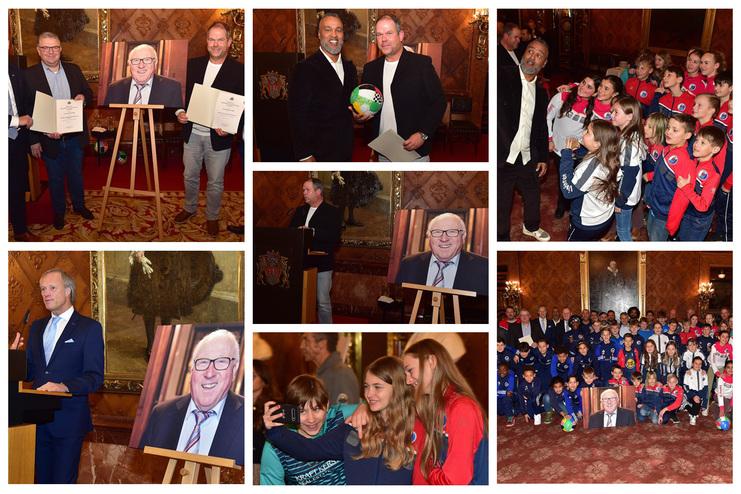 Veranstaltung mit mehreren Personen, Portraitausstellung und Kindern in Sportkleidung beim feierlichen Anlass.