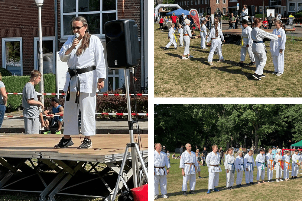 Auf einer B&uuml;hne spricht eine Frau in Karateanzug ins Mikrofon; im Hintergrund trainieren Kinder in Karateanz&uuml;gen.