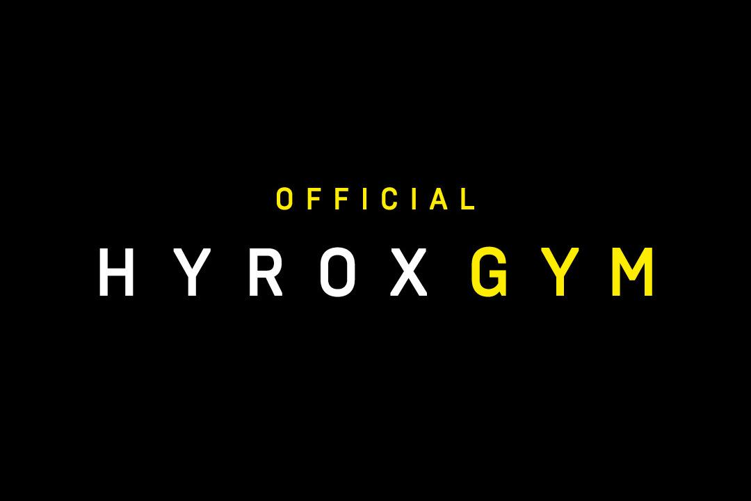 Logo von HYROX GYM mit schwarzem Hintergrund, gelben und wei&szlig;en Buchstaben, betont "OFFICIAL" und "GYM".